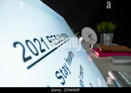 Writing 2021 resolutions on a computer Stock Photo