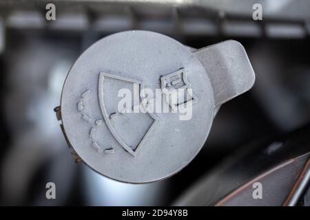 Black windshield washer fluid cap. Wiper water reservoir filling cover. Stock Photo