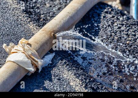 Leaking hose pipe Stock Photo - Alamy