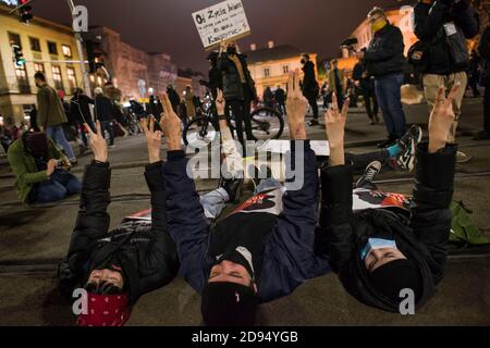 Warsaw, Poland. 02nd Nov, 2020. Protesters laying down on the tram tracks while making gestures during the demonstration.Protesters took to the streets of Poland to protest against a constitutional court ruling that would impose a near-total ban on abortion in Poland. Protesters in Warsaw occupied several key roundabouts in the city center to block traffic. Credit: SOPA Images Limited/Alamy Live News Stock Photo