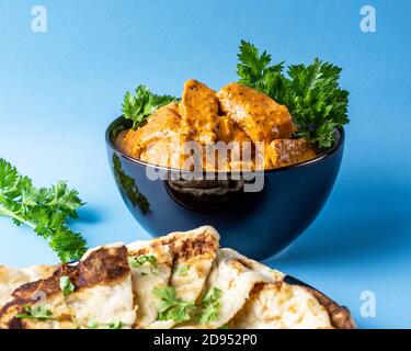 Indian snacks samosa garlic naan bread butter chicken on wooden table Stock Photo