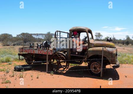 Old rusty ute on display with a mannequin and pigs statues outside Windorah, a sleepy remote Outback town, Queensland, QLD, Australia Stock Photo