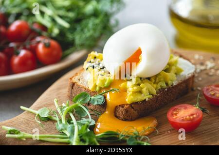 Toast with avocado and egg garnished with sesame seeds. Healthy breakfast lunch or snack Stock Photo