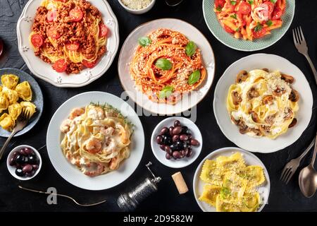 Pasta, many different varieties, shot from the top on a black background, Italian food flat lay Stock Photo