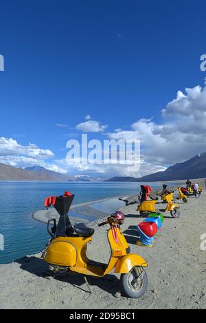 Motorbikes for hire at Pangong Lake in summer. Located in the Changthang region, Ladakh, it is one of the world's highest saltwater lakes Stock Photo