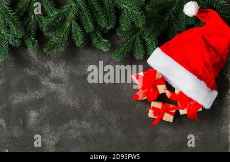 Christmas gift boxes in Santa Claus hat. Stock Photo
