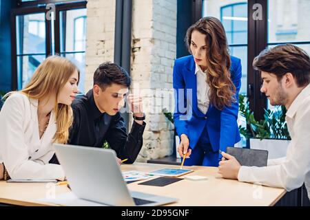 Businesswoman show graph on tablet to colleagues Stock Photo