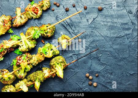 Vegetable kebab from broccoli cabbage.Fried cabbage on wooden skewers.Copy space Stock Photo