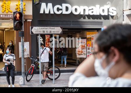 Hong Kong, China. 03rd Nov, 2020. Pedestrians wearing face masks wait to cross the street in front of the American multinational fast-food hamburger restaurant chain, McDonald's, in Hong Kong. Credit: SOPA Images Limited/Alamy Live News Stock Photo