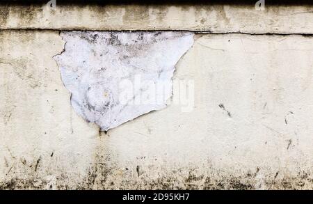 Peeling white paint on a white concrete wall Stock Photo