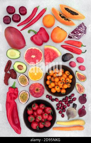 Fruit & vegetables high lycopene & anthocyanins to reduce cholesterol for a healthy heart with foods also high in antioxidants, omega 3 & vitamins. Stock Photo