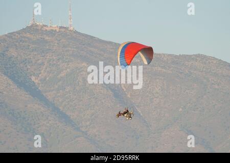 Motorized tandem paraglider, paragliding in front of mountain in southern Spain, Stock Photo