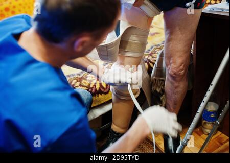 The prosthetist removes the measure from a person with a disability, man with amputee. Stock Photo