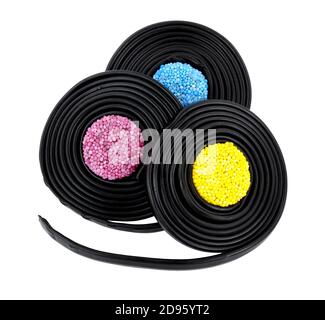Liquorice Catherine wheels, soft liquorice strips wrapped around jelly buttons isolated on a white background Stock Photo