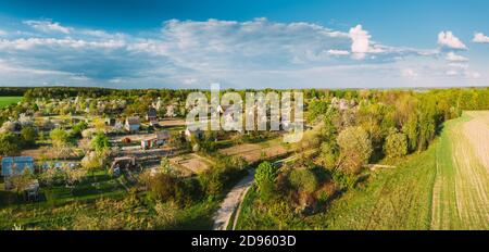 Countryside Rural Landscape With Small Village, Gardens And Green Field In Spring Summer Day. Elevated View. Panorama.