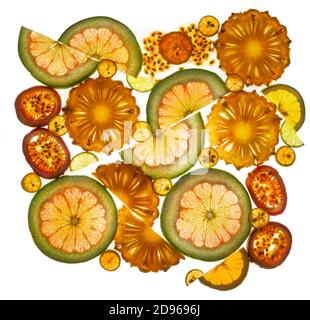 Cross-section of a pomelo, pineapples, lime, passion fruits and fortunella on a lumen. Isolated on a white background. Half and whole slices. Stock Photo