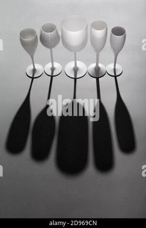 High angle view of wine glasses group and its shadow on gray background Stock Photo