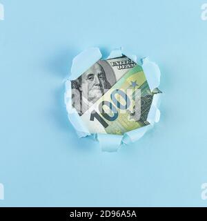 Money in the hole of torn paper. One Hundred Dollar Bill. Business and finance concept with copy space Stock Photo