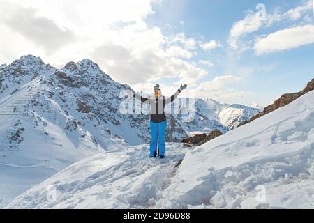 Happy hiker winning reaching life goal, success, freedom and happiness, achievement in mountains. Stock Photo