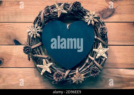 Rustic Christmas wreath on wooden planks background with copy space Stock Photo