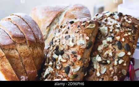 A selection of freshly baked bread rolls and buns covered with mixed seeds Stock Photo