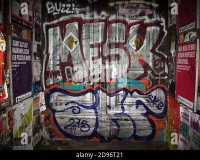 Graffiti - ridden entrance door of residential building in Berlin, Germany Stock Photo