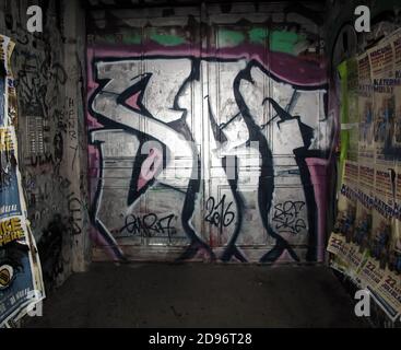 Graffiti - ridden entrance door of residential building in Berlin, Germany Stock Photo