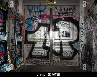 Graffiti - ridden entrance door of residential building in Berlin, Germany Stock Photo