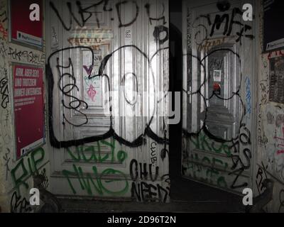 Graffiti - ridden entrance door of residential building in Berlin, Germany Stock Photo