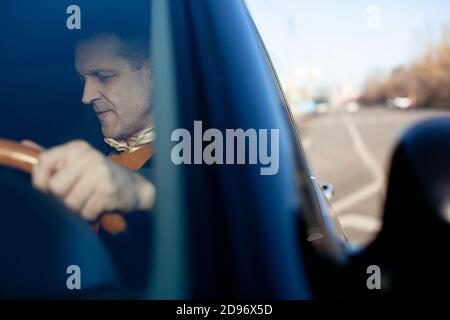 Russia, Moscow - 02 November 2014: Male businessman talking on mobile phone while driving his car. Stock Photo