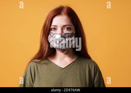 young woman wearing homemade everyday cloth face mask or community mask - covid-19 corona virus pandemic hygiene concept Stock Photo