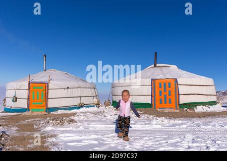 Yurt in the snow with a child, Altai mountains, West Mongolia, Mongolia