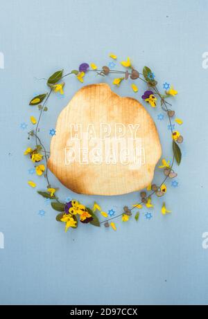 'Happy Pesach' card with flowers and kosher matzo bread. Passover wishes. Stock Photo