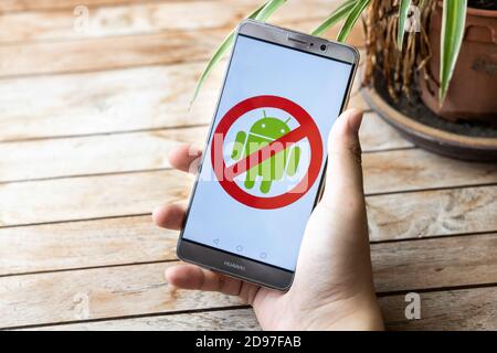 Concept of hand removing Android OS from Huawei. U.S. companies began to curb sales to Chinese telecom Huawei Stock Photo