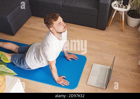 Young man doing yoga in his living room Stock Photo