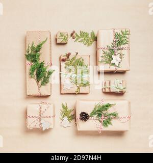 Some nice Christmas presents wrapped in craft paper arranged on kraft background, top view Stock Photo