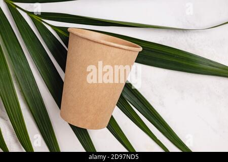 Coffee cup made of paper and green palm leaf Stock Photo