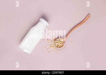 Bottle of non dairy oat milk on pink background Stock Photo
