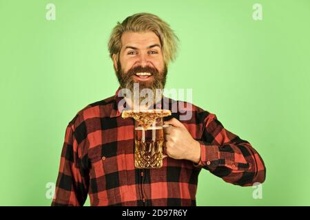 nice pub menu. man watching football while drinking beer and eating pizza. eating pizza and drinking. take-away pizza. Best party here. bachelor men club. Having fun and drink in bar. Stock Photo