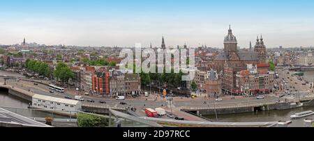 Amsterdam, Netherlands - May 18, 2018: Panoramic cityscape of Amsterdam city center with canal system and narrow houses with  landmark buildings, busy Stock Photo