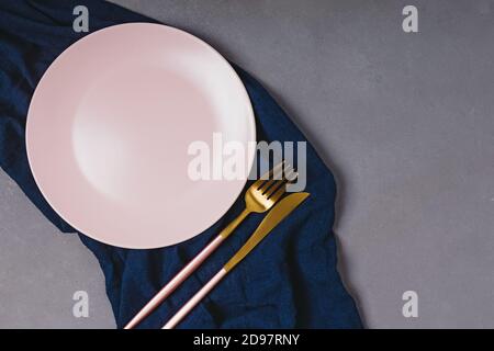 Empty pink plate on dark grey table Stock Photo