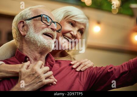 Smiling elderly married couple holding hands while making selfie together in the evening outdoors. Lifestyle concept Stock Photo