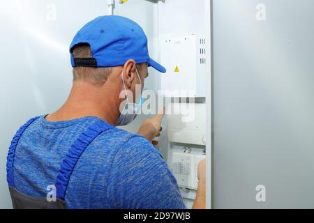 The inspector checks the condition of the fire alarm system. Stock Photo