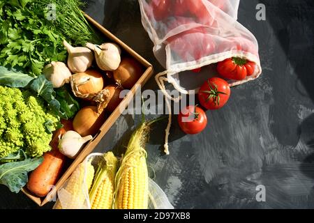 Fresh fruits and vegetables in reusable shopping bags. Stock Photo