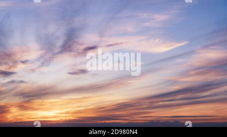 Sunset in the cloudy pastel colored sky. Natural background Stock Photo
