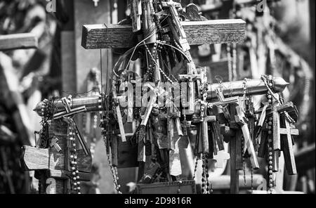 Crucifixion of Christ and a large number of crosses at Hill of Crosses. Hill of Crosses is a unique monument of history and religious folk art in Siau Stock Photo