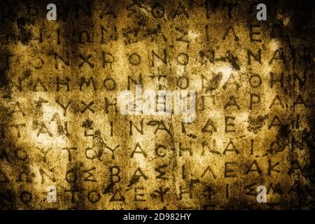 Ancient slab of marble with Greek symbols written on the surface with a grungy border textured effect Stock Photo
