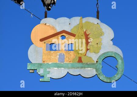 Hanging Sign Advertising Real Estate Agency or Estate Agent Sign France. Rustic House & Key Stock Photo