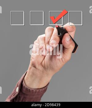 hand with pen mark the check boxes Stock Photo