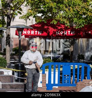 Reston, VA. USA -- November 2, 2020. Photo of a mason working with trowel and brick in Reston Town Center. Stock Photo